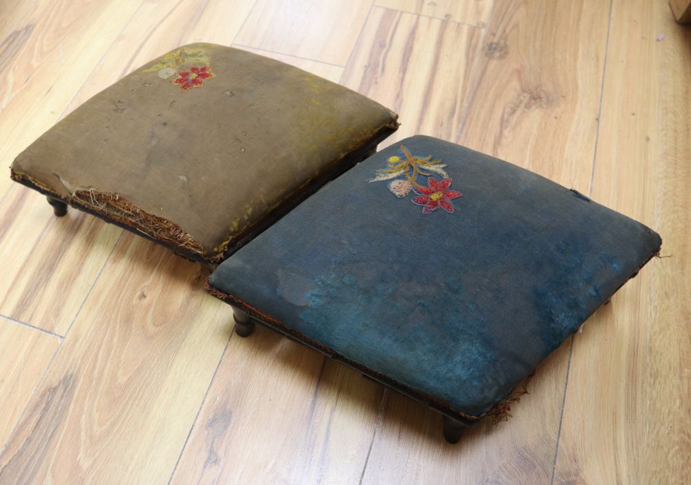 A pair of ebonised and upholstered footstools, lozenge shape, 40cm approx.